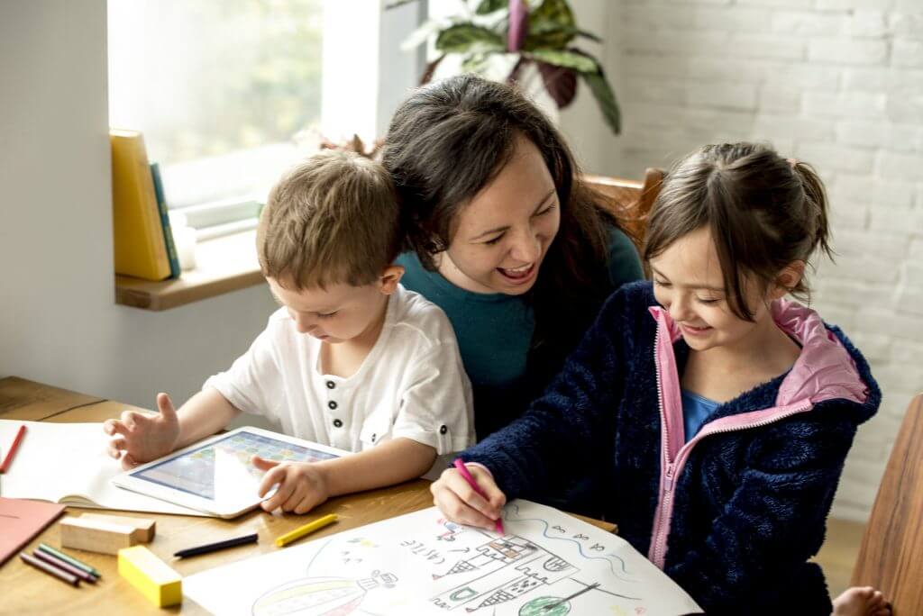 Mother teaching her kids at home
